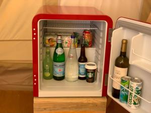 a refrigerator filled with lots of bottles of alcohol at Eco Glamping. Private luxury tent in Alfambras. in Aljezur