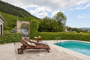 a bench sitting next to a swimming pool at Villa Ava in Kotor