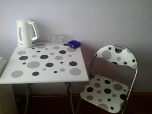 a white table with polka dots next to a chair at Ana in Split