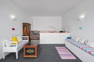 a living room with two couches and a table at Nissia Beach Apartments & Suites in Kamari
