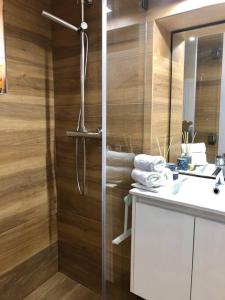 a bathroom with a shower with a sink and a mirror at A&C Cozy apartment Elvas in Elvas