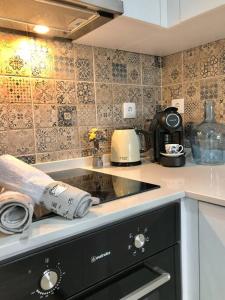 a kitchen with a sink and a counter top at A&C Cozy apartment Elvas in Elvas