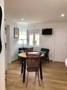 a dining room with a table and chairs and a television at A&C Cozy apartment Elvas in Elvas