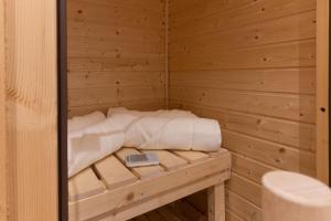 a sauna with a bed in a wooden room at Chalet Casita in Engelberg