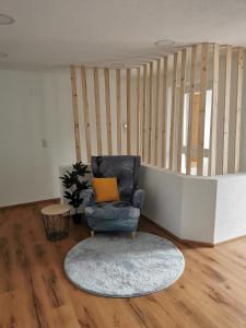 a living room with a chair and a rug at Appartement Sonnenrot in Sankt Lorenzen ob Murau