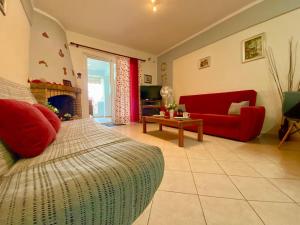 a living room with a bed and a red couch at DeVal • Kiveri apartment • in Kiveri