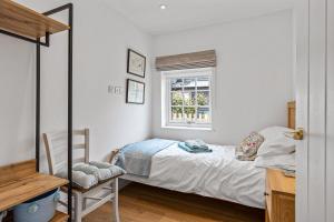 a small bedroom with a bed and a window at Apple Tree Cottage in Welwyn