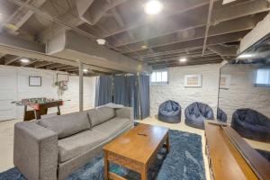a living room with a couch and a table at Pet-Friendly St Louis Home with Grill and Backyard in Richmond Heights