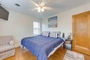 a bedroom with a bed and a ceiling fan at Pet-Friendly St Louis Home with Grill and Backyard in Richmond Heights