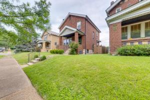 a large brick house with a grass yard at Pet-Friendly St Louis Home with Grill and Backyard in Richmond Heights