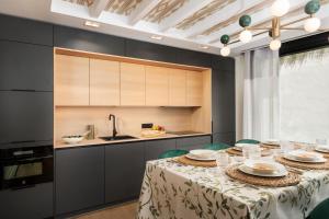 a dining room with a table and a kitchen at Apartamentos La Zagalilla in Málaga