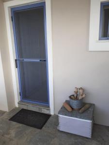 a large glass door with a teddy bear in a bucket at Seaside resort / Lemnos 