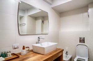 a bathroom with a sink and a mirror at Apartament Kenya in Bacău +13 photos