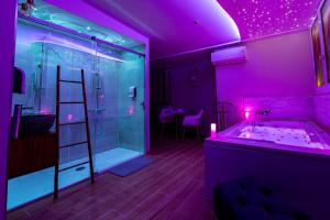 a purple bathroom with a shower and a sink at Studio romantique jacuzzi ou spa balneo privatif et jardin Au temps des cerises La Ciotat in La Ciotat