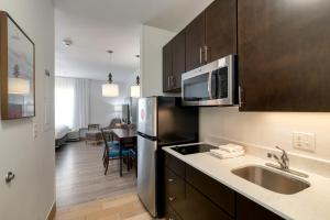 a kitchen with a sink and a refrigerator at TownePlace Suites by Marriott Dallas McKinney in McKinney