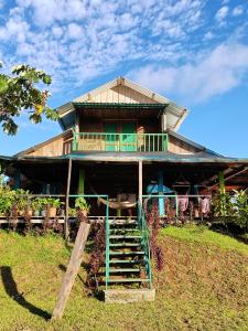a house sitting on top of a hill at Finca La Puesta del Sol - Miramar de Sierpe in Sierpe +59 photos