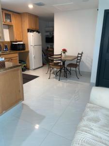 a kitchen and dining room with a table and chairs at Bedroom and Bathroom 4 in Boca Raton +6 photos