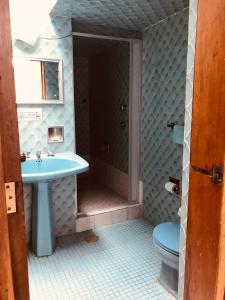 a bathroom with a sink and a toilet at Casa Tigris in Mexico City