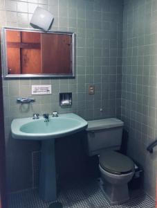 a bathroom with a sink and a toilet at Casa Tigris in Mexico City