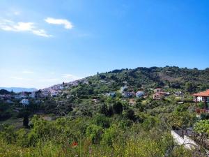 a view of a town on a hill at Cozy Mountain View in Glossa