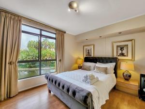 a bedroom with a large bed and a large window at Family-Friendly Home with Ample Space in Cape Town