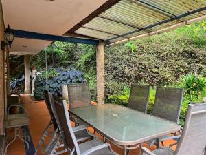 a table and chairs on a patio with a pergola at 300 squared meters house in the city! in Envigado