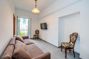 a living room with a couch and a tv at In the heart of Finalmarina in Finale Ligure
