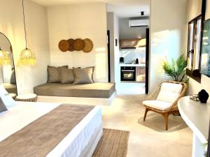 a bedroom with a bed and a couch in a room at Palma Deluxe House in Sarti
