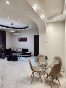 sala de estar con mesa de cristal y sillas en Kavala Lux Apartment, en Kavala