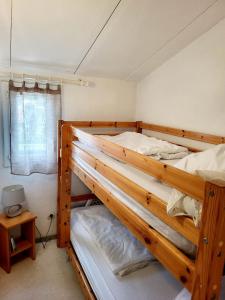 two bunk beds in a room with a window at Gîte VILLA 34 Résidence Le Grand Bleu in Vendres