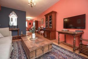 a living room with a couch and a flat screen tv at Apartment Old Centre - Panska in Bratislava