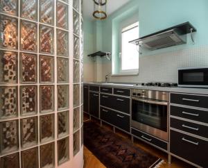 a kitchen with a large glass block wall at Apartment Old Centre - Panska in Bratislava