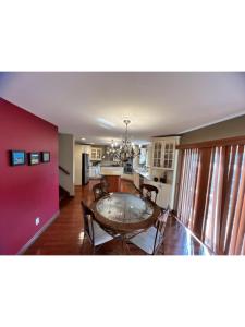 a dining room and kitchen with a table and chairs at Hotel/Home in Windsor