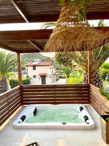 a jacuzzi tub on a patio with at Palma Deluxe House in Sarti
