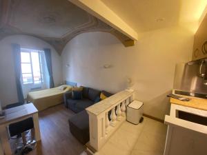 Lovely studio - heart of Menton, near the beach. في مينتون: غرفة معيشة مع أريكة ومطبخ