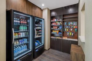 a kitchen with a refrigerator filled with lots of drinks at La Quinta Inn & Suites by Wyndham Sulphur Lake Charles in Sulphur