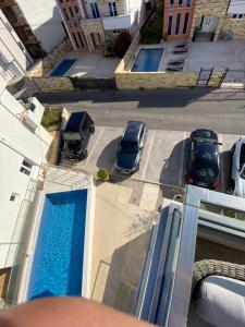 an overhead view of two cars parked next to a swimming pool at Emma Lux Apartment in Dobra Voda