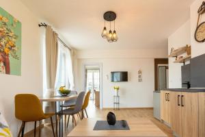 a kitchen and dining room with a table and chairs at Villa Lеvandi in Sinemorets
