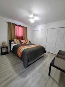 a bedroom with a large bed and a couch at Sol Miami #1 with free parking on premises in Miami