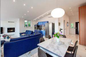 a living room with a blue couch and a table at villa Ana in Preko