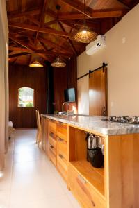 a kitchen with a large counter with a sink at Jardim das Pipas in Garibaldi