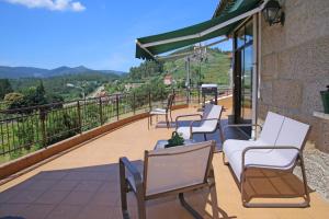 a row of chairs on a balcony with a view at Os de Rey in Pontevedra