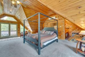 um quarto com uma cama num chalé de madeira em 3-Acre Benezette Cabin with Hot Tub, Grill and Mtn View em Benezette