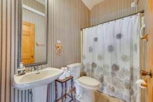 a bathroom with a sink and a toilet and a shower at 3-Acre Benezette Cabin Hot Tub, Grill and Mtn View in Benezette +23 photos