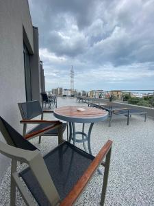 a table and chairs on the roof of a building at YAMADA in Năvodari