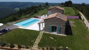 an external view of a stone house with a swimming pool at Villa San Silvestro in Oprtalj +26 photos