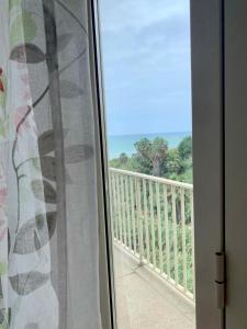 a window with a view of a balcony at La casetta del mare in Gela