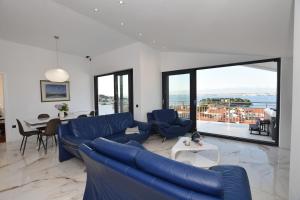 a living room with a blue couch and a table at Villa Ana in Preko