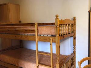 a bunk bed in a room with a chair at Appartement Enchastrayes, 2 pièces, 5 personnes - FR-1-165A-144 in Enchastrayes