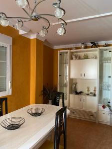 a dining room with a white table and chairs at Apartamento en el parque natural in El Cabo de Gata +4 photos